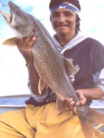 At Nueltin Lake, guide George Merasty can pose with the big fish for photographs, but must release them back into the waters under the lake's "no-trophy" rule, put in place to preserve the genetic population.